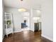 Bright living room flowing into kitchen, featuring hardwood floors, and modern decor at 1360 S Hudson St, Denver, CO 80222