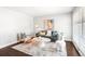 Bright and airy living room features stylish furnishings, accent rug and a modern aesthetic at 1360 S Hudson St, Denver, CO 80222