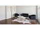 Stylishly furnished living room featuring a plush black sofa, modern coffee tables, and chic decor at 1360 S Hudson St, Denver, CO 80222
