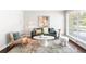 Stylish living room featuring a modern aesthetic with natural light through a large window at 1360 S Hudson St, Denver, CO 80222