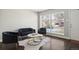 Comfortable living room setup with black velvet furniture, modern decor, and natural light at 1360 S Hudson St, Denver, CO 80222
