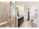 Bathroom featuring a large walk-in shower, a soaking tub, and a double sink vanity with granite countertops at 5221 E 143Rd Dr, Thornton, CO 80602
