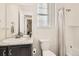 Bright bathroom with a shower/tub combo, granite countertop, and a large mirror and window at 5221 E 143Rd Dr, Thornton, CO 80602