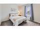 Bright bedroom featuring a large window and neutral decor at 5221 E 143Rd Dr, Thornton, CO 80602