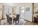 Cozy dining room featuring a large window for plenty of natural light and a sliding glass door to the patio at 5221 E 143Rd Dr, Thornton, CO 80602