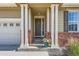 Inviting entryway with brick accents, decorative wreath, and neutral-colored siding at 5221 E 143Rd Dr, Thornton, CO 80602