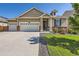 Charming single-Gathering home with a well-maintained lawn, brick accents, and a three-car garage at 5221 E 143Rd Dr, Thornton, CO 80602