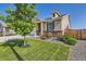 Charming home with lush green lawn, mature tree, and well-maintained landscaping at 5221 E 143Rd Dr, Thornton, CO 80602