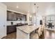 Modern kitchen with granite countertops, stainless steel appliances, and a breakfast bar at 5221 E 143Rd Dr, Thornton, CO 80602