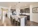 Bright kitchen featuring stainless steel appliances, granite countertops, large island, and hardwood floors at 5221 E 143Rd Dr, Thornton, CO 80602