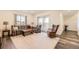Cozy living room with a plaid sofa and love seat, sliding glass doors, and wood laminate flooring at 5221 E 143Rd Dr, Thornton, CO 80602