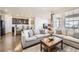 Spacious living room open to the kitchen, featuring comfortable seating and modern decor at 5221 E 143Rd Dr, Thornton, CO 80602