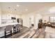 Bright living room featuring a granite kitchen island, stainless appliances, and wood laminate floors at 5221 E 143Rd Dr, Thornton, CO 80602
