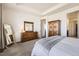 Spacious main bedroom featuring ample closet space, a full-length mirror, and an ensuite bathroom at 5221 E 143Rd Dr, Thornton, CO 80602