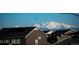 Mountain view behind new homes and rooftops, creating a scenic backdrop at 5221 E 143Rd Dr, Thornton, CO 80602
