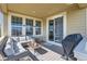 Cozy covered patio with comfortable wicker seating, perfect for relaxing or entertaining guests at 5221 E 143Rd Dr, Thornton, CO 80602