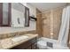 This bathroom features brown tiled walls and decorative accents at 10150 E Virginia Ave # 11-202, Denver, CO 80247