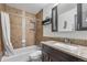 Bathroom with granite countertops, a tile shower, and modern fixtures at 10150 E Virginia Ave # 11-202, Denver, CO 80247
