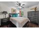 Well-lit bedroom with dark furniture, a ceiling fan and a window at 10150 E Virginia Ave # 11-202, Denver, CO 80247