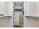 An organized walk-in closet offers shelving and a place to store suitcases at 10150 E Virginia Ave # 11-202, Denver, CO 80247