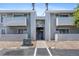 Apartment building exterior with gray siding, balconies, and an open stairway at 10150 E Virginia Ave # 11-202, Denver, CO 80247