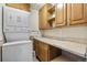 Functional laundry room offering a stacked washer/dryer and storage cabinets at 10150 E Virginia Ave # 11-202, Denver, CO 80247