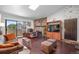 This living room is fitted with a brick fireplace, plush seating, and sliding glass doors to the outside at 10150 E Virginia Ave # 11-202, Denver, CO 80247