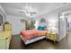 Bright bedroom featuring wood floors, a ceiling fan, and comfortable furniture at 10150 E Virginia Ave # 11-202, Denver, CO 80247