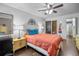Bright bedroom featuring wood floors, a ceiling fan, and comfortable furniture at 10150 E Virginia Ave # 11-202, Denver, CO 80247