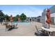 The outdoor pool area features lounge chairs and tables for relaxation at 10150 E Virginia Ave # 11-202, Denver, CO 80247