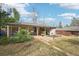 A home's backyard boasts a covered patio, brickwork, and a grassy lawn under a partly cloudy sky at 7076 S Verbena Cir, Centennial, CO 80112