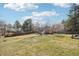 A sprawling backyard features a large grassy area with mature trees, enclosed by a wooden fence at 7076 S Verbena Cir, Centennial, CO 80112