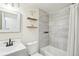 Updated bathroom with modern fixtures, including white vanity and tiled shower/tub at 7076 S Verbena Cir, Centennial, CO 80112