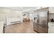 Open floorplan kitchen features a large stainless refrigerator and connects to the dining area at 7076 S Verbena Cir, Centennial, CO 80112