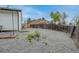 Backyard with gravel and partial view of neighboring houses and partial fencing at 9664 W Grand Ave, Littleton, CO 80123