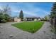 Spacious backyard with lawn, gravel, storage shed, patio with pergola, and privacy fence at 9664 W Grand Ave, Littleton, CO 80123
