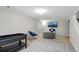 Finished basement area with carpet, furniture, and TV at 9664 W Grand Ave, Littleton, CO 80123