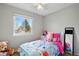 Well-lit bedroom with window view, carpet, and decorations at 9664 W Grand Ave, Littleton, CO 80123