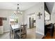 Bright dining room with stylish chandelier, tile floors, and easy access to the kitchen at 9664 W Grand Ave, Littleton, CO 80123