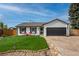 Charming single-story home featuring a well-manicured lawn, attached garage, and red lawn chairs at 9664 W Grand Ave, Littleton, CO 80123