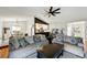 Inviting living room featuring hardwood floors, open layout, stylish furnishings, and a ceiling fan at 9664 W Grand Ave, Littleton, CO 80123