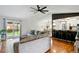 Open-concept living room with access to a deck, hardwood floors, and a view of the kitchen at 9664 W Grand Ave, Littleton, CO 80123