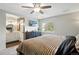 Comfortable main bedroom features a ceiling fan, TV, and ensuite bathroom at 9664 W Grand Ave, Littleton, CO 80123
