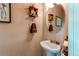 Small powder room with pedestal sink and decorative accents at 14700 E 104Th Ave # 3602, Commerce City, CO 80022