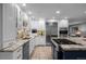 Kitchen with white cabinets, stainless appliances, and a navy island with granite counters and cooktop at 2 Sterling Ave, Cherry Hills Village, CO 80113