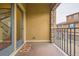 Private balcony space with iron railing, tan walls, and an inviting floral welcome mat at 9470 Loggia St # D, Highlands Ranch, CO 80126