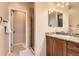 Well-lit bathroom with granite vanity and modern fixtures, with a glass-enclosed shower at 9470 Loggia St # D, Highlands Ranch, CO 80126