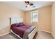 Cozy bedroom featuring plush carpet, a ceiling fan, a window, and a comfortable bed at 9470 Loggia St # D, Highlands Ranch, CO 80126