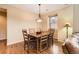 Inviting dining room features wood floors, a stylish light fixture, and a window with natural light at 9470 Loggia St # D, Highlands Ranch, CO 80126