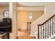 Inviting home entryway featuring hardwood floors, staircase with carpet runner, and neutral wall color at 9470 Loggia St # D, Highlands Ranch, CO 80126